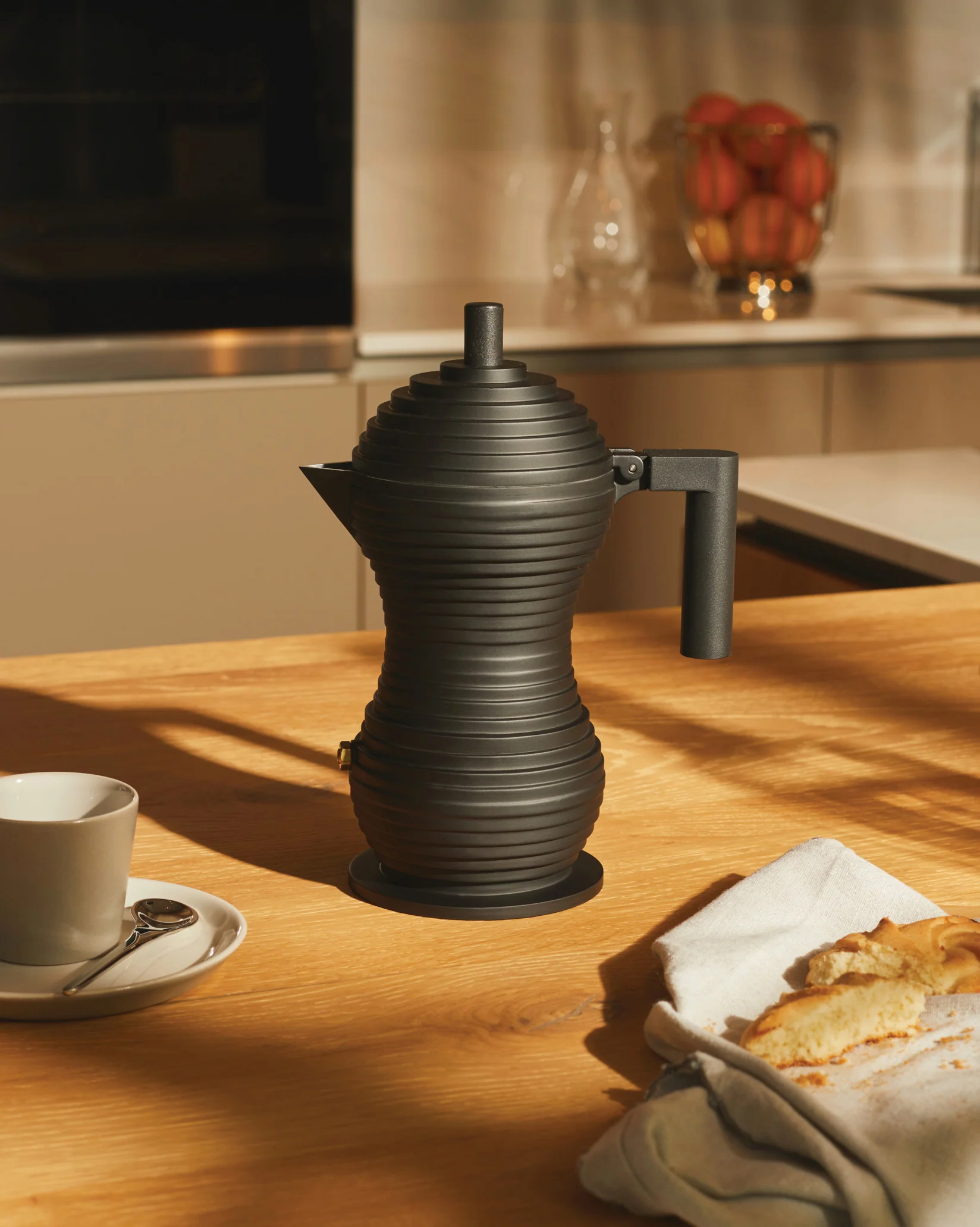 Alessi Pulcina Espresso Maker in black aluminium cast with a black handle and knob in the shape of a chick or pulcina in italian