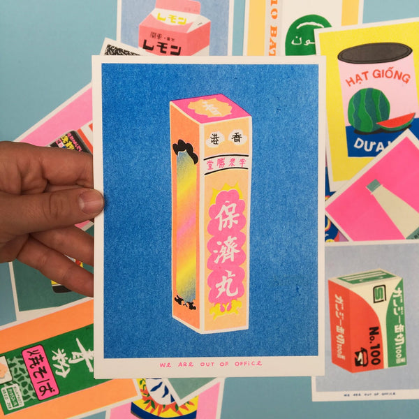 Vibrant risograph print of a pink and orangy  box of Chinese Po Chaii pills on a deep blue background held by a hand on top of other colourful prints. Designed and printed by Dutch company We are out of office.