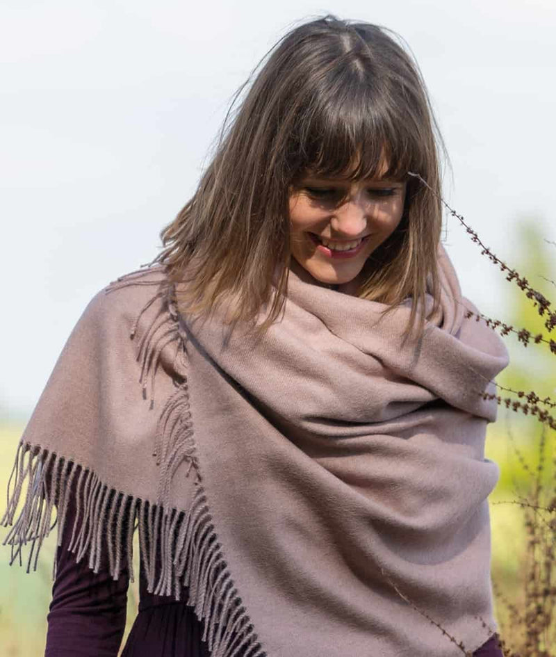 lifestyle picture of handmade super soft baby alpaca shawl by so cosy in pale pink available online and at the store