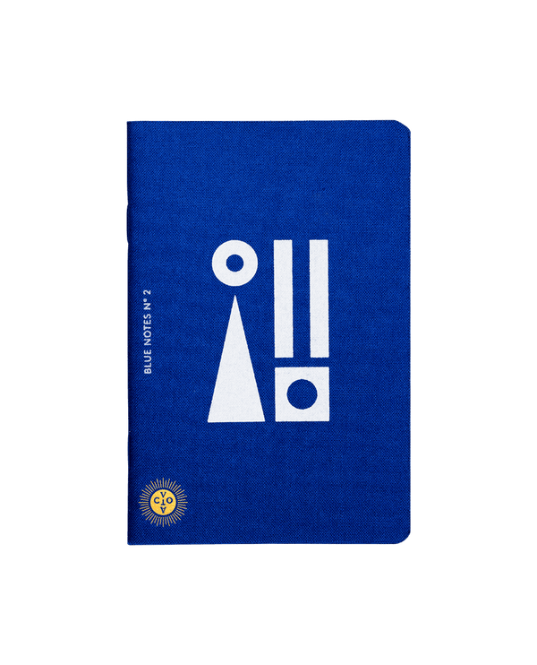 Deep Mediterranean blue notebook with white motifs and Octaevo's logo stamped in gold. Available at cuemars.com