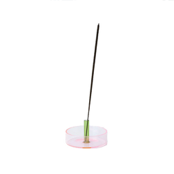 Pink and green glass incense holder with an incense stick on it by British brand Block Design, available at www.cuemars.com