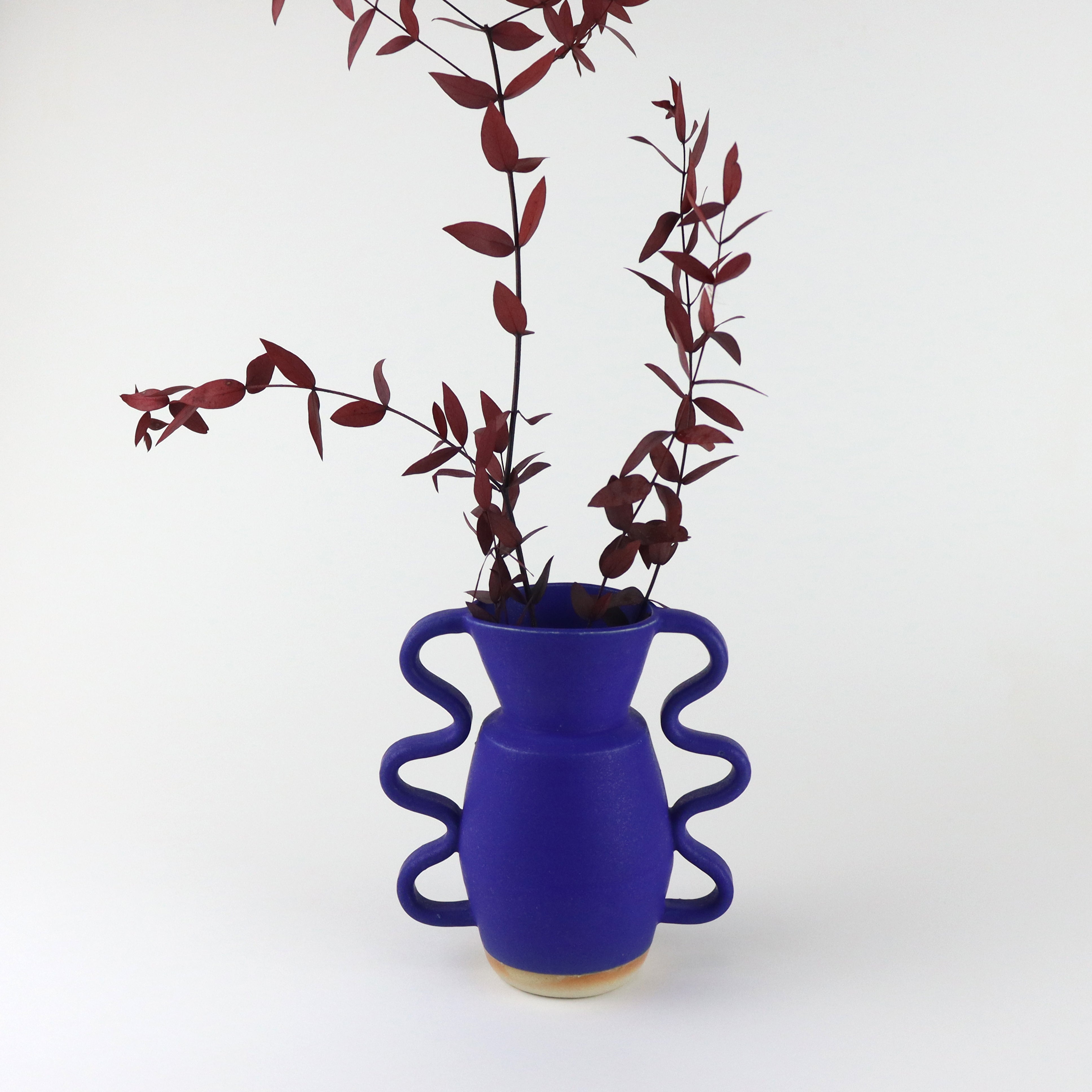 handmade stoneware vase with wiggled handles in both sides, hand painted in a mediterranean deep blue colour. Handmade by ceramicists Sophie Alda, available now at cuemars.com