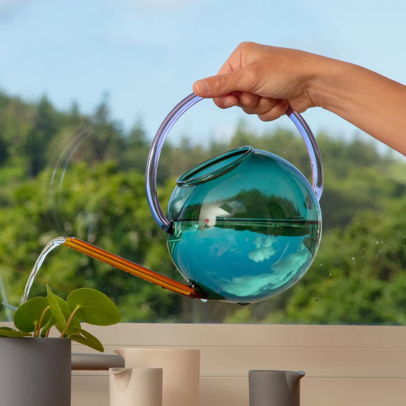 Colourful glass watering can by British homeware brand Block Design, available at www.cuemars.com