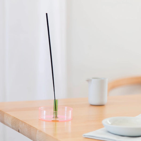Pink and green glass incense holder with an incense stick on it by British brand Block Design, available at www.cuemars.com