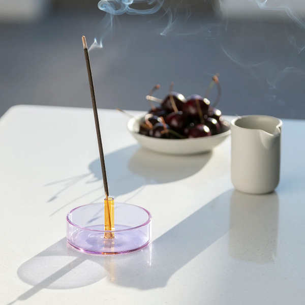 Lilac and Peach glass incense holder with an incense stick on it by British brand Block Design, available at www.cuemars.com