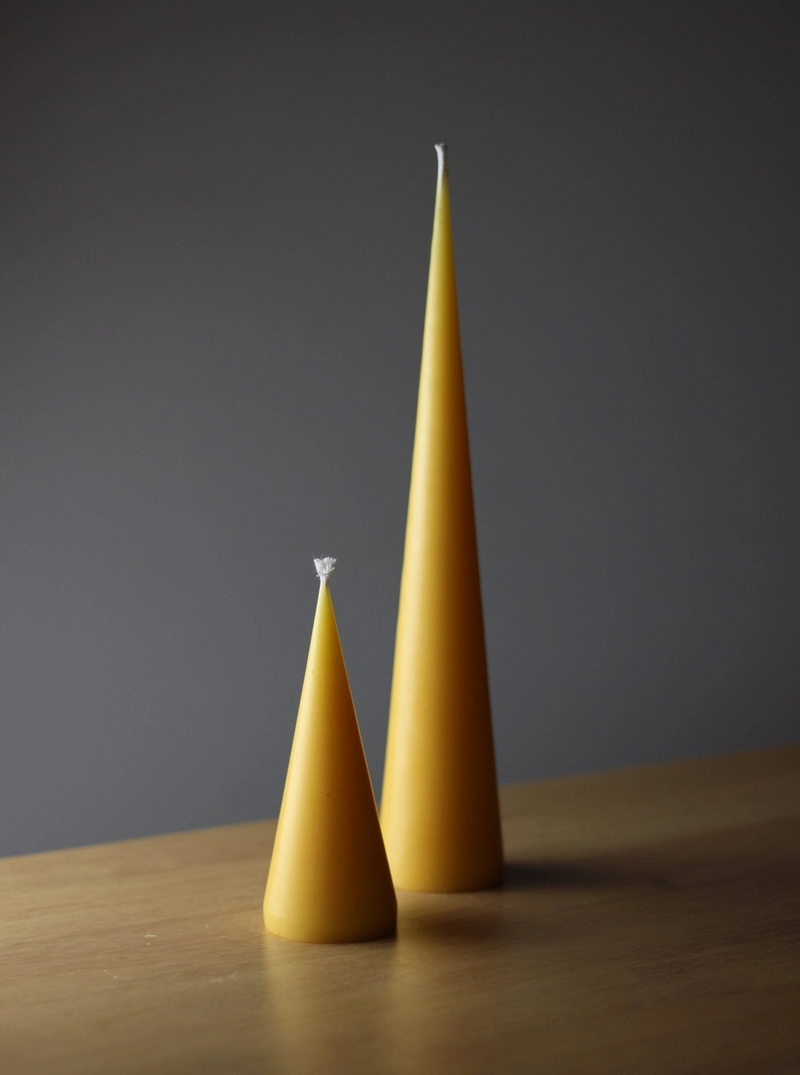 Two cone beeswax pillar candles by Bzzwax, available at www.cuemars.com