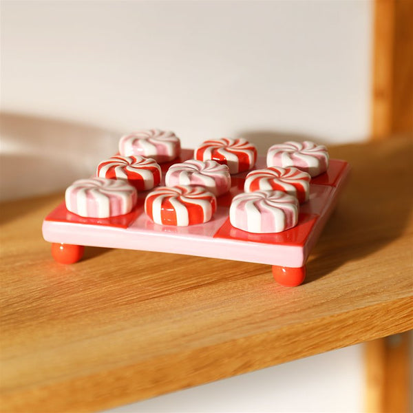 Ceramic tic tac toe inspired by candy with pieces in pink and red, by Klevering. Available at www.cuemars.com