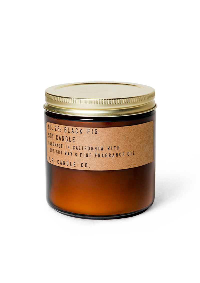 soy wax scented candle in an amber glass jar and metallic lid with a kraft sticker that states Black Fig Soy Candle by PF Candle Co.