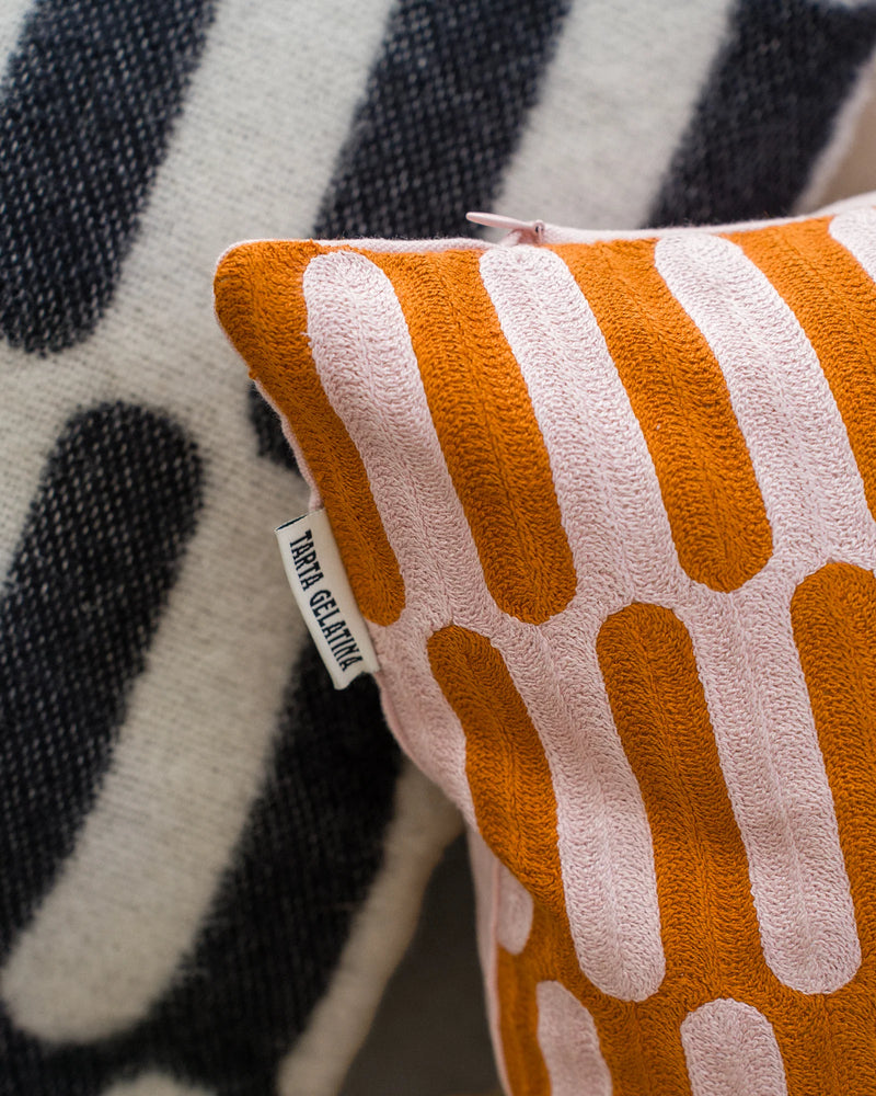 Ziggy Cushion by Tarta Gelatina – 45 × 45 cm hand-embroidered organic cotton cushion cover in wavy orange & pink pattern, sustainable artisan design