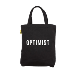 Black cotton tote bag with the typography Optimist in white by the School of Life. 
