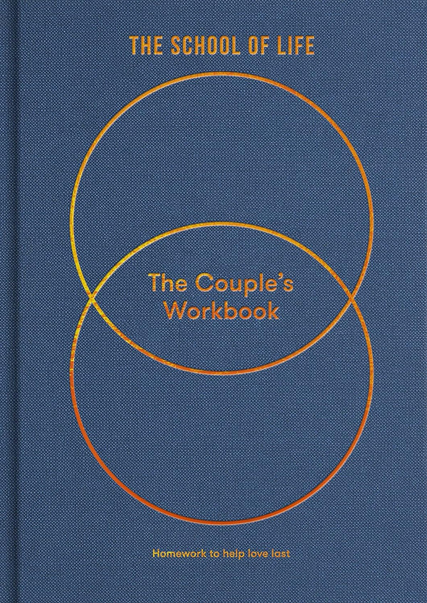 Blue book with white circle called The Couple's Workbook which is a guide to greater serenity, by The School of Life. Available at cuemars.com  Edit alt text