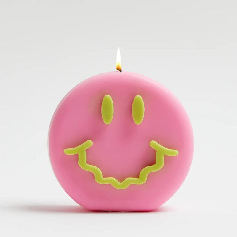 Pink and green smiley soy wax candle with a wavy smile, by UK based independent brand Wavey Casa, available at www.cuemars.com
