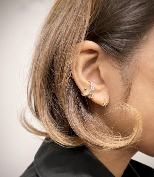 Sterling Silver Ear Cuff featuring the moon craters on a woman's ear. Designed and handcrafted by independent maker Momocreatura