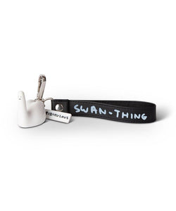 An abstract white swan keyring with a black handle that says Swan-Thing and a small white tag that says ridiculous by Scottish artist David Shrigley