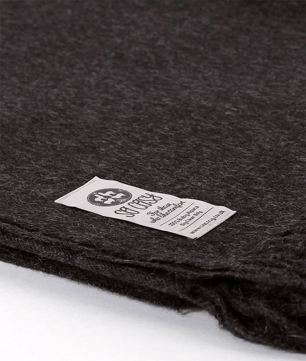 Close up Woven Charcoal Grey Baby Alpaca soft blanket designed in the UK by So Cosy