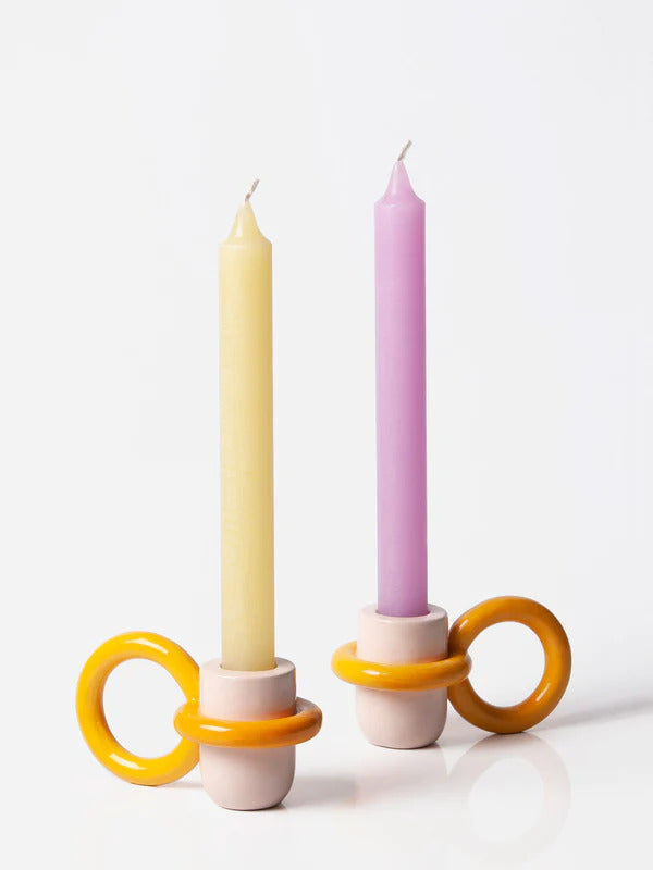pink and yellow candle holder with a big ring as a holder, by ceramicist Ariana de Luca. Available at www.cuemars.com