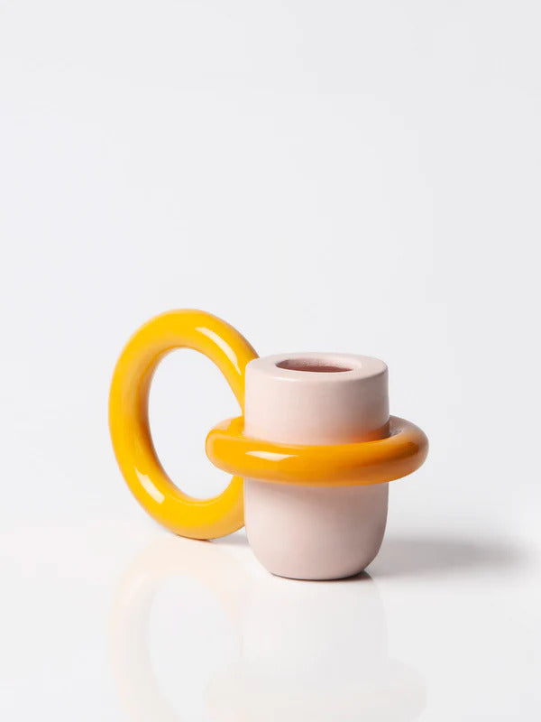 pink and yellow candle holder with a big ring as a holder, by ceramicist Ariana de Luca. Available at www.cuemars.com