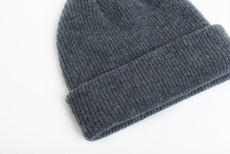 details of natural merino wool beanie hat in dark grey