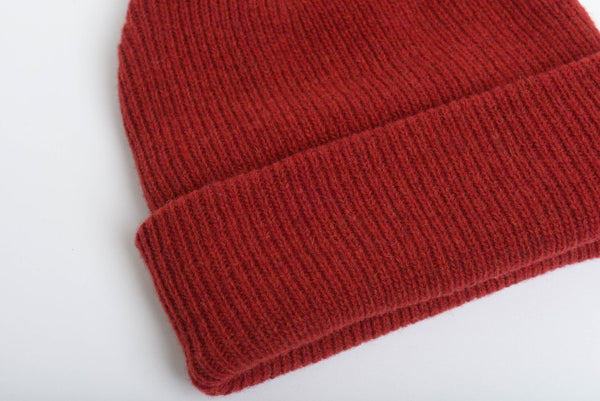 close up details of natural merino wool beanie hat in red