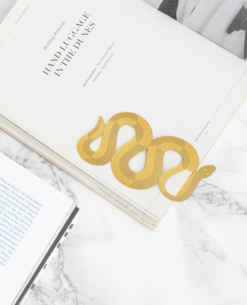 Close up Picture of a finely-cut metal gold snake bookmark by Octaevo available at cuemars.com