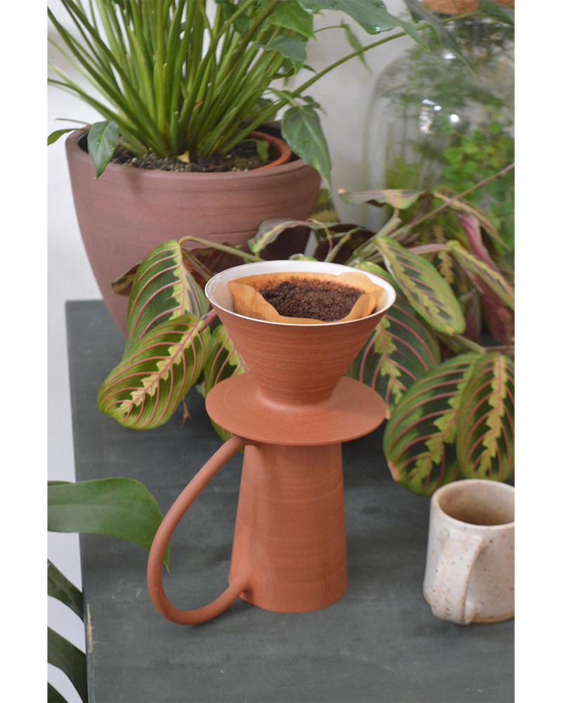 close up picture of hand thrown coffee mug in red Canadian stoneware in a minimalist design with an oversized handle