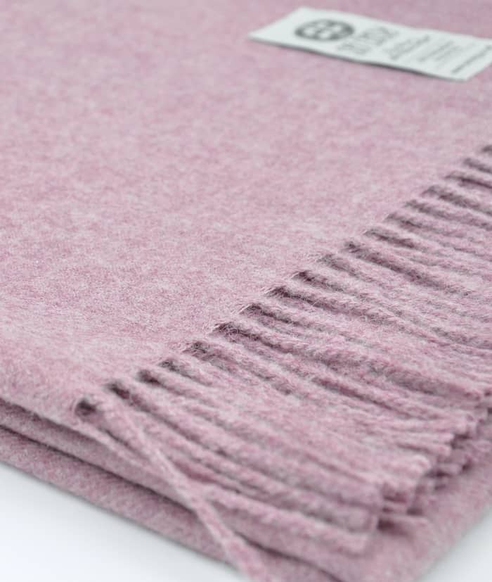 close up picture of handmade super soft baby alpaca throw by so cosy in chalk pink melange available online and at the store