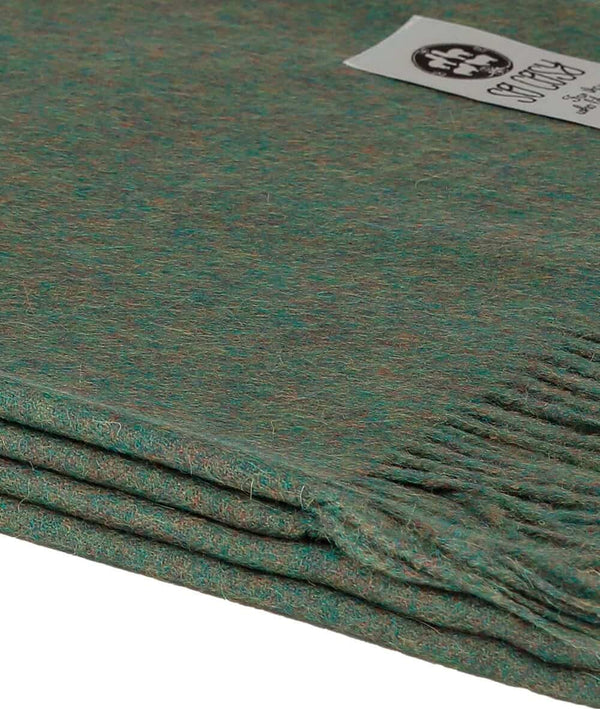 close up picture of handmade super soft baby alpaca throw by so cosy in olive green available online and at the store