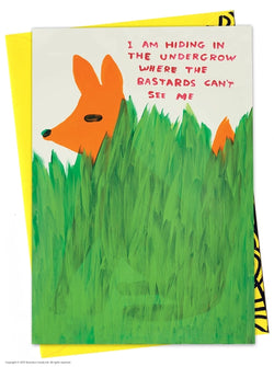 an orange fox hidden behind grass greeting card with the typography I am hiding in the undergrow where the bastards can't see me by David Shrigley, available to purchase at cuemars.com