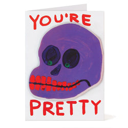 sticker puffy greeting card by david shrigley illustrating a purple skull with red teeth with the typography You're pretty, available to purchase at cuemars.com