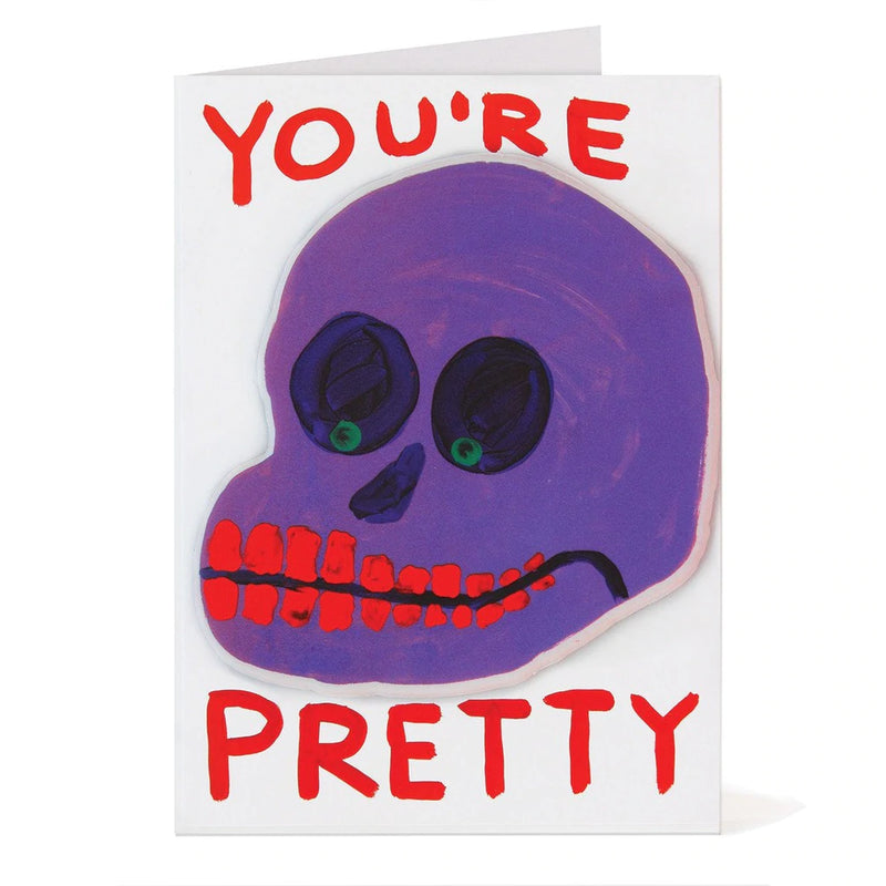 sticker puffy greeting card by david shrigley illustrating a purple skull with red teeth with the typography You're pretty, available to purchase at cuemars.com