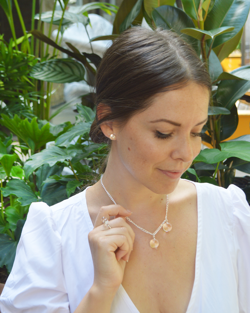 Picture of statement stud earrings handmade by Deborah Tseng in Sterling Silver and spheres in rock crystal