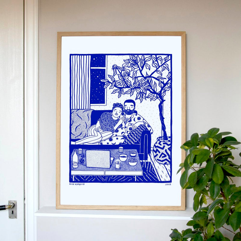 A woman and a man cuddling on a sofa watching something on their laptop in their living room, by French visual artist Elise Esposito. Available at www.cuemars.com