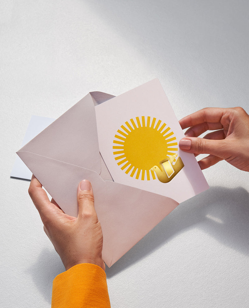 Greeting card with a big bright sun illustration and a metallic bookmark shaped as a bird, by Spanish design studio Octaevo. Available at cuemars.com