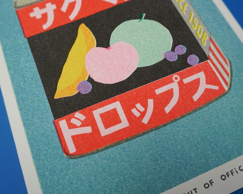 Colourful tin can of Japanese candy Sakuma Drops, made as a riso print by We are out of office