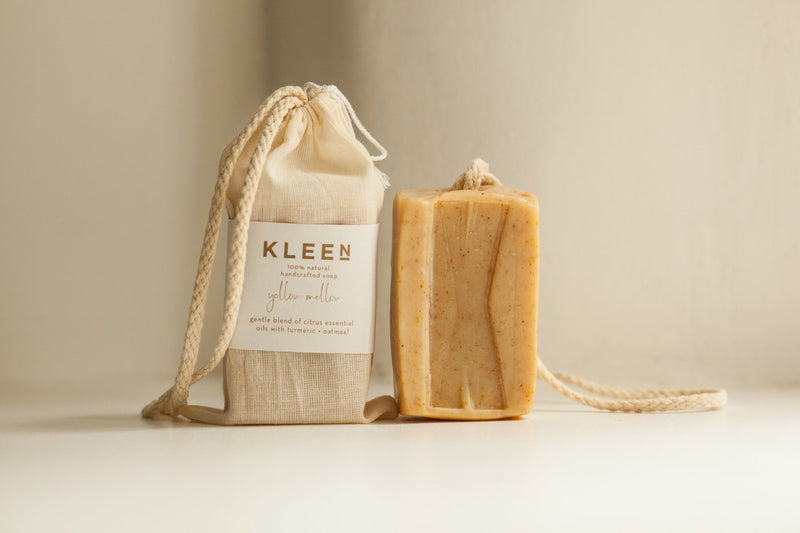 Picture with two citrusy exfoliating soaps on a cotton rope by natural skincare brand Kleen soaps ideal for oily skin and cotton travel bag