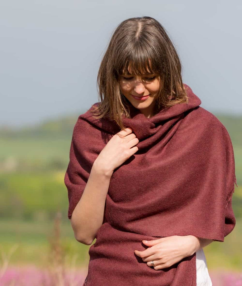 lifestyle picture of handmade super soft baby alpaca shawl by so cosy in burgundy available online and at the store