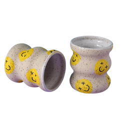 Wavy coffee cups without handles with yellow smiley faces. Designed and handmade by Minx Factory and sold at cuemars.com