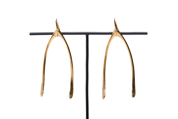 close up details of handmade wishbone earrings in 24ct gold plated silver 