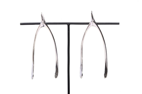 Close up details of handmade wishbone earrings in sterling silver