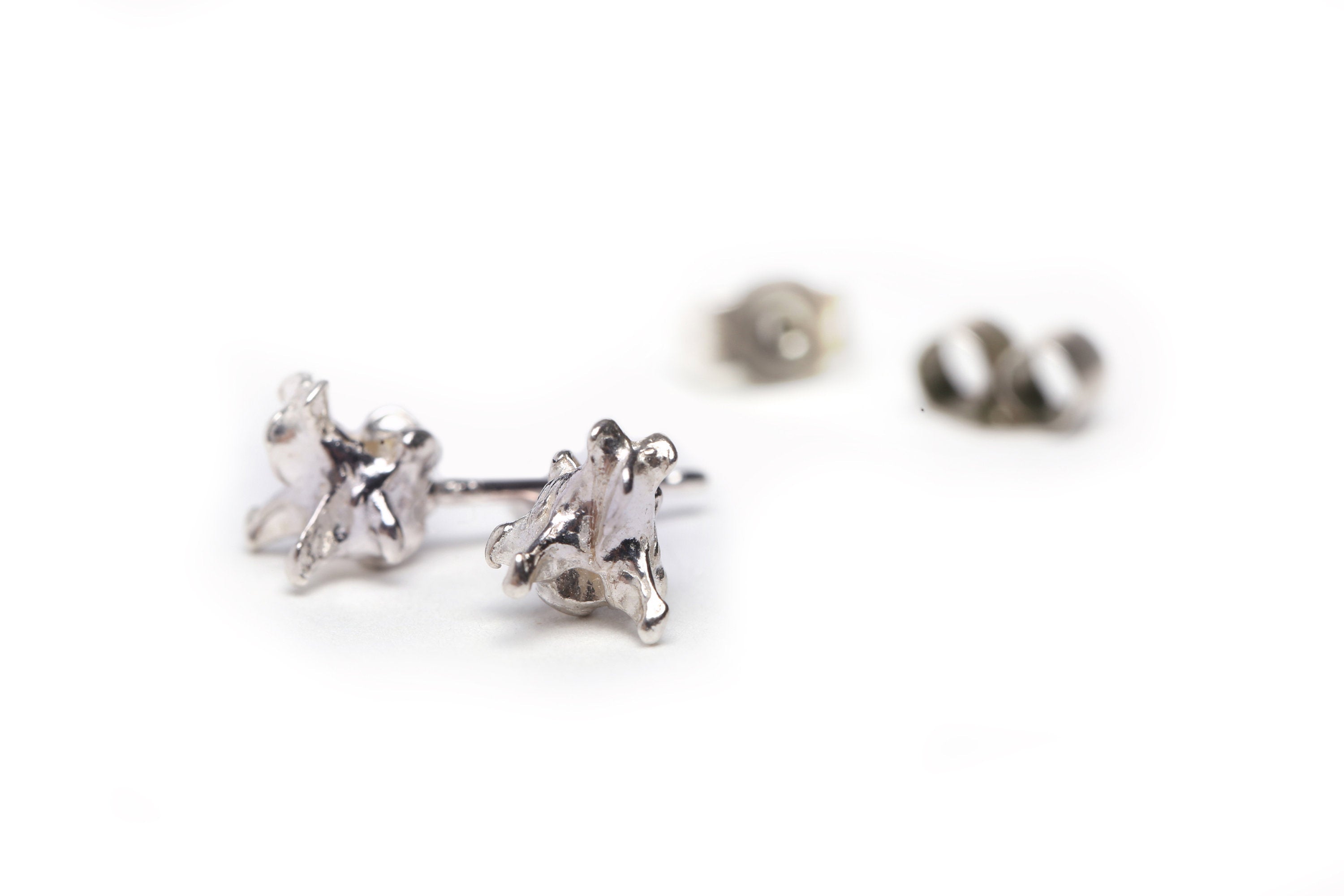 Handmade mole vertebrae ear studs cast in sterling silver by misan jewellery