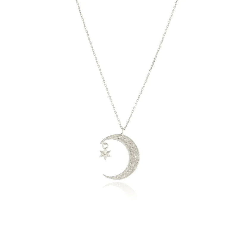 Crescent moon silver necklace with a small hanging  6 point silver star, by Momocreatura. Available at www.cuemars.com