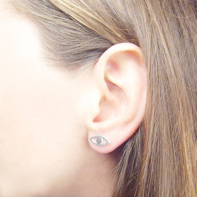 Model ear wearing a silver eye stud by Momocreatura, jewellery designer in London