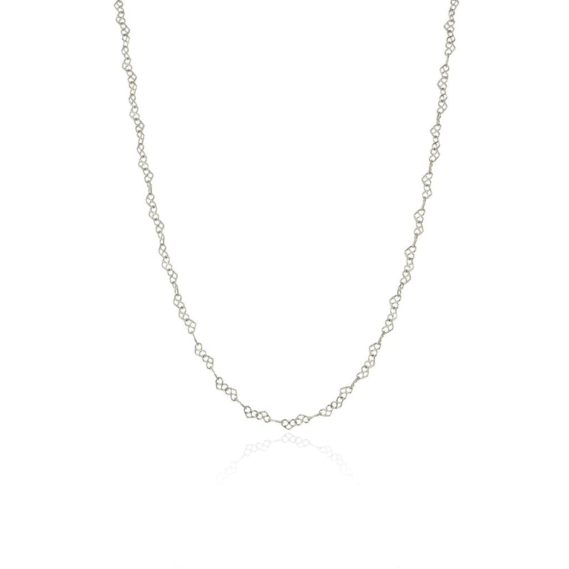 Pretzel like hearts linked in a chain necklace in sterling silver. handcrafted by momocreatura. Available at www.cuemars.com
