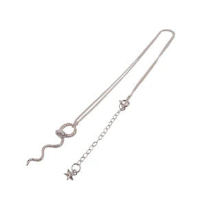 silver snake necklace with intricate skin details made by hand in London by Momocreatura. Avialable at www.cuemars.com