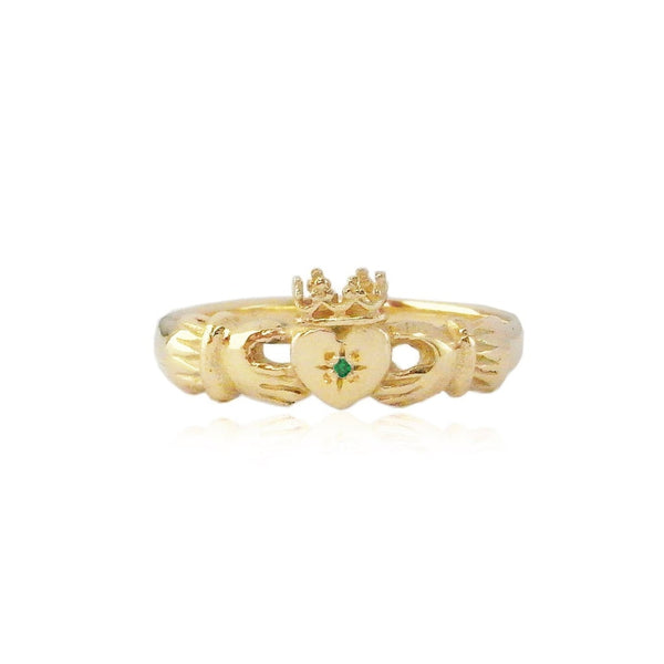 Claddagh Gold ring featuring an emerald in the center of the heart 