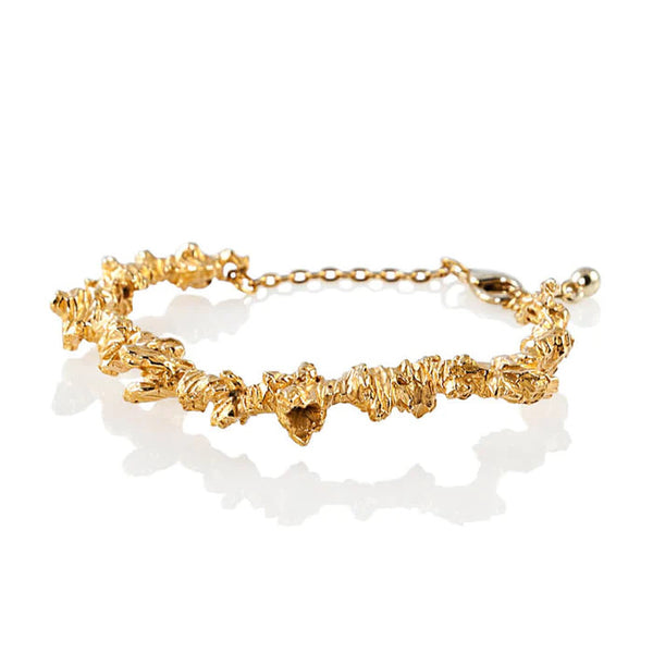 Irregular and textured gold plated silver statement bracelet, handmade by Niza Huang. Available at www.cuemars.com