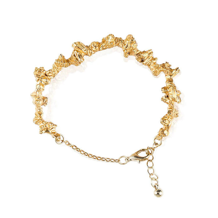 Irregular and textured gold plated silver statement bracelet, handmade by Niza Huang. Available at www.cuemars.com