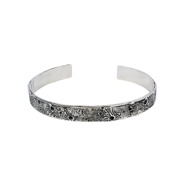 Silver moon bangle featuring the moon craters that have been individually marked by hand by independent maker Momocreatura