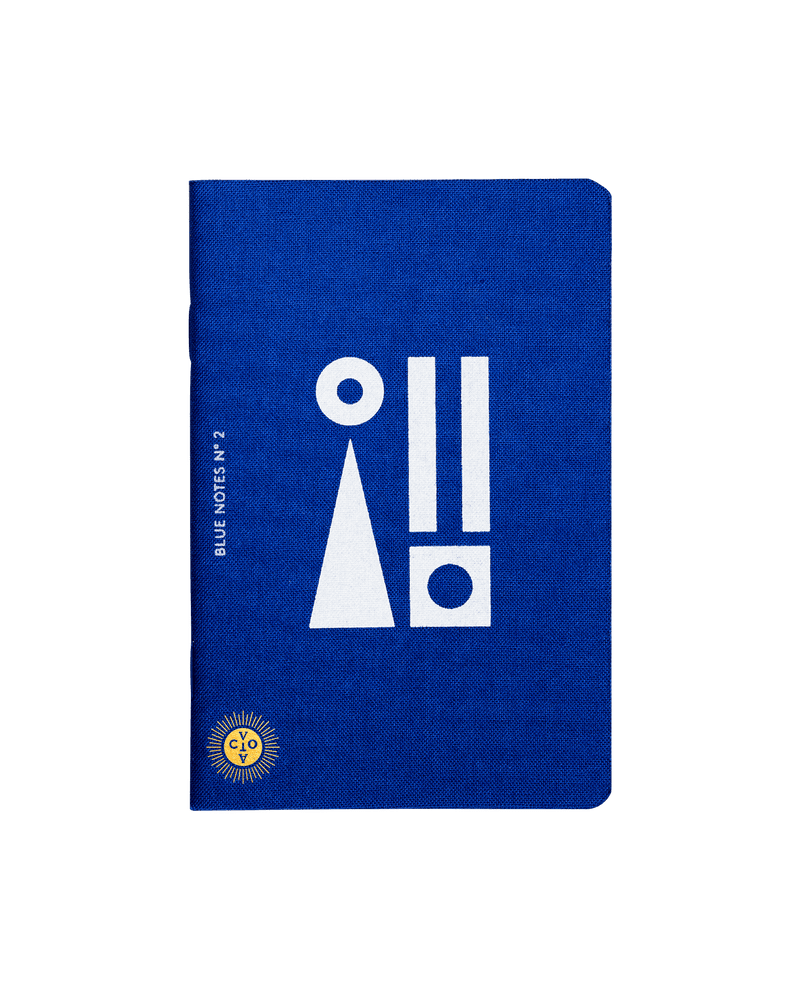 Deep Mediterranean blue notebook with white motifs and Octaevo's logo stamped in gold. Available at cuemars.com