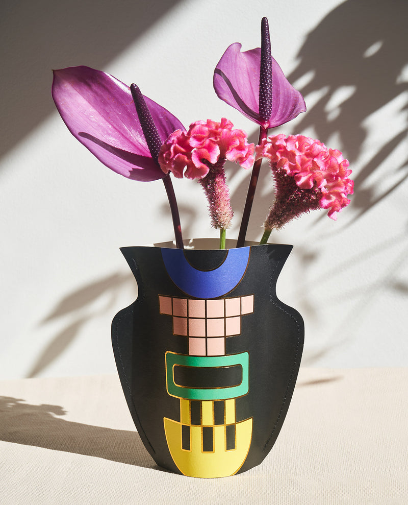lifestyle Picture of a handmade waterproof mini paper vase by Barcelona based design studio Octaevo with flowers